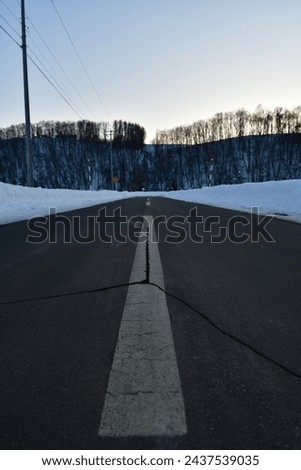 lonely road in snow hokkaido japan countryside. High quality photo  Royalty-Free Stock Photo #2437539035