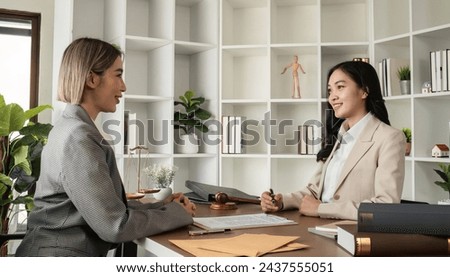 A young lawyer and businesswoman are discussing legal advice on signing a business contract. Insurance or financial contract signing