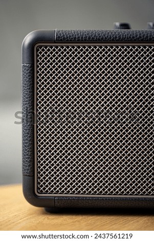 Square music speaker, metallic mesh texture close-up. Royalty-Free Stock Photo #2437561219