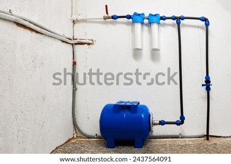 Water storage pressure diaphragm tank, hydraulic accumulator of reverse osmosis for plumbing system of home water supply. Royalty-Free Stock Photo #2437564091
