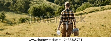 back view of hard working modern farmer walking with bucket and jar of milk in hands, banner