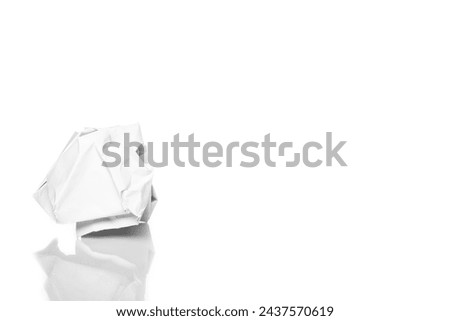 Crumpled paper on a white background. A crumpled lump . Depression of ideas. Royalty-Free Stock Photo #2437570619