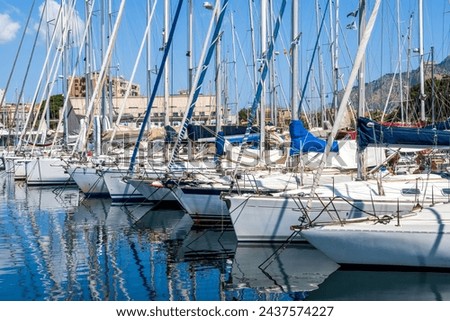 boats and yachts on pier in marine city port with masts and bulidings and blue sky on background , water cityscape of urban port Royalty-Free Stock Photo #2437574227