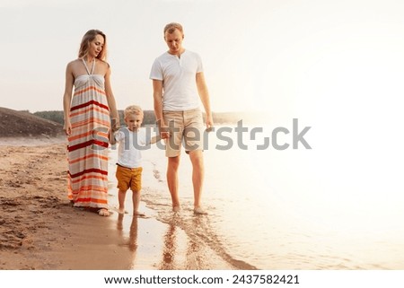 a young family walks on the seashore. parents play with their son on the seashore. White background.