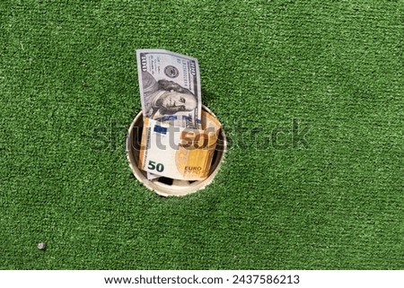 Mini Golf club, money on the artificial grass