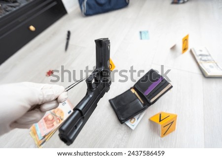 Close up on hands of unknown man forensic police investigator collecting evidence in the plastic bag at the crime scene investigation Royalty-Free Stock Photo #2437586459
