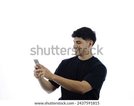 Smiling young girl looks at her cell phone with white background. Perfect for digital advertising, social networking and modern technology concepts