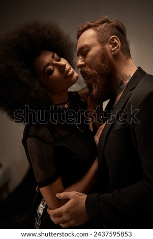 chic curly african american woman in dress seducing tattooed boyfriend with beard, date night Royalty-Free Stock Photo #2437595853
