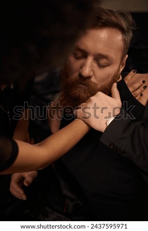passionate night of interracial couple at home, curly african american woman seducing tattooed man Royalty-Free Stock Photo #2437595971
