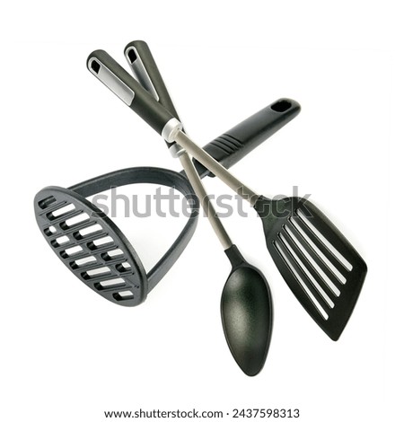 Kitchen utensils, potato masher, spatula and spoon isolated on white background. Collage. Royalty-Free Stock Photo #2437598313