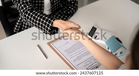Real estate agents and customers shake hands to congratulate on signing a contract to buy a house with land and insurance, handshake and good response concept