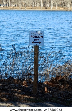 A sign that reads "Caution Poison Ivy".