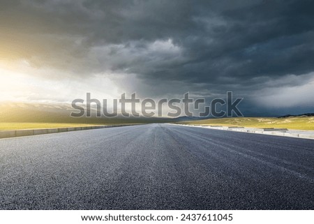 Straight asphalt highway road and mountain nature background at sunset