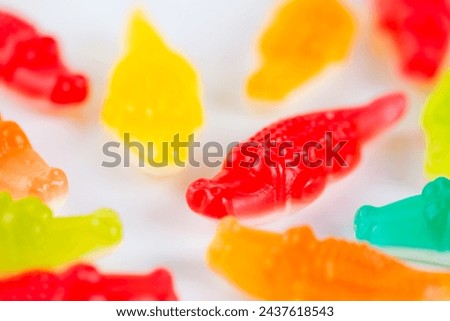 Swedish candy, chewy candies in the shape of crocodiles on a white. Royalty-Free Stock Photo #2437618543