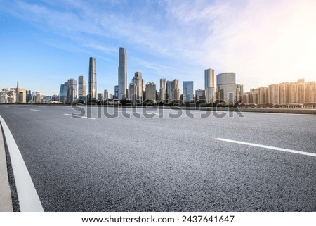 Asphalt highway road and modern city buildings at sunset in Guangzhou Royalty-Free Stock Photo #2437641647