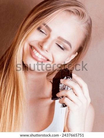 young cute blond girl eating chocolate