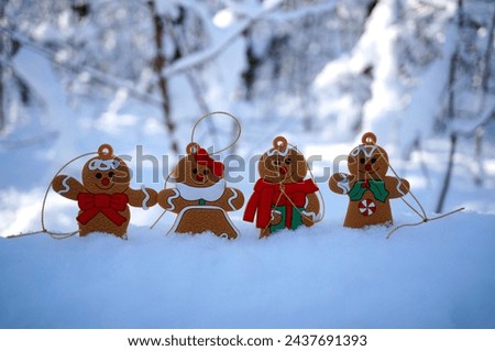 Gingerbread men on a background of snow. Christmas tree toys.