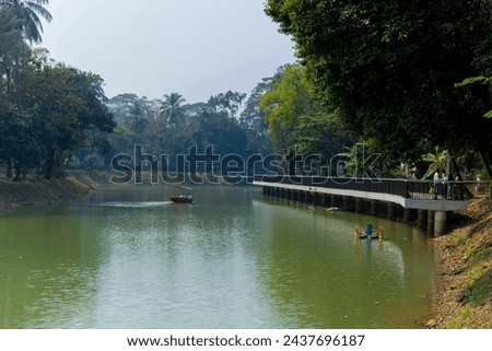 Beautiful Ramna park with lake, trees and side walkway. Dhaka, Bangladesh Royalty-Free Stock Photo #2437696187