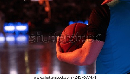 referee holding basketball during game
