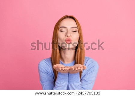 Portrait of gorgeous lovely girl with foxy hairdo wear blue pullover send you air kiss close eyes isolated on pink color background Royalty-Free Stock Photo #2437703103