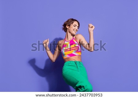 Photo of cheerful lovely woman wear trendy clothes dance freestyle celebrate festive event occasion isolated on purple color background