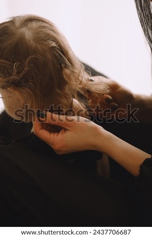 Close up photo of mom stroking her little baby girl hair. The concept of cheerful childhood and family Royalty-Free Stock Photo #2437706687