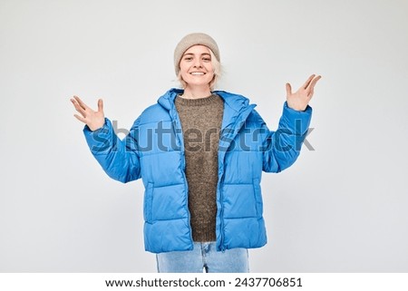 Portrait blond young woman happy face smiling joyfully with raised palms and shocked open mouth isolated on white studio background
