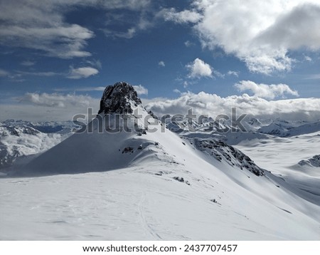 Ski tour on the Spitzmeilen and Wissmeilen in Glarnerland. Ski mountaineering in very strong winds. Skimo in winter with beautiful deep snow. Skitour Flumserberg. High quality photo. High quality.