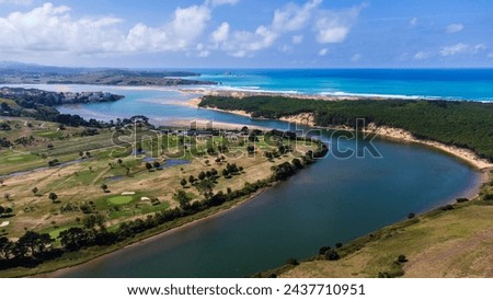 The Pas River, its mouth, Liencres Dunes Natural Park, and the Atlantic Ocean seen from the Abra del Pas viewpoint in Liencres, Cantabria, Spain. Royalty-Free Stock Photo #2437710951