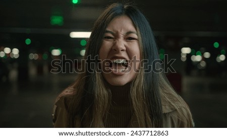 Mad angry crazy Asian korean chinese japanese girl shout in car parking furious woman annoyed businesswoman client speak loud screaming talk solve conflict feel anger rage talking scream webcam view Royalty-Free Stock Photo #2437712863