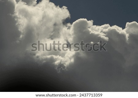 White cumulus clouds on a dark blue sky Royalty-Free Stock Photo #2437713359