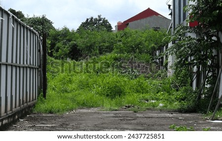 a plot of empty land fenced off for the purpose of building a house.