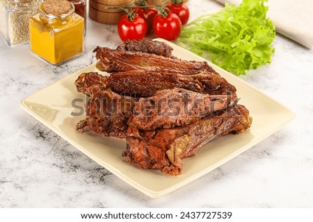 Roasted duck wings with sauce and spices
