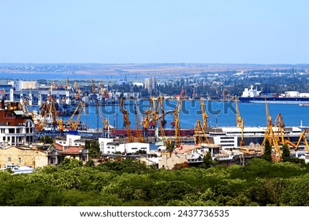 Cargo crane and grain dryer in port Odessa, Ukraine Royalty-Free Stock Photo #2437736535