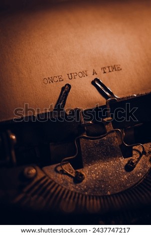 ONCE UPON A TIME typed words on a vintage typewriter. Close up. Antique Typewriter. Royalty-Free Stock Photo #2437747217