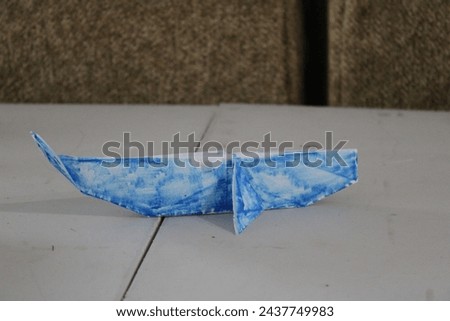 Homemade origami whale on table