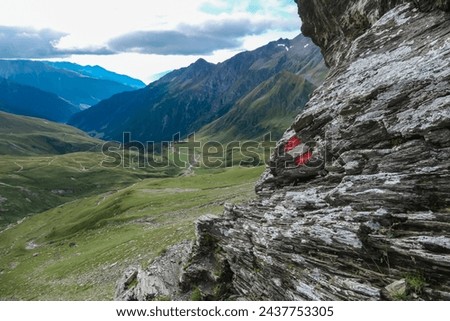 Unique rock formation with panoramic view of majestic mountain peaks of High Tauern, Carinthia Salzburg, Austria. Idyllic marked hiking trail in Goldberg group in wilderness of Austrian Alps. Hike