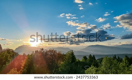 Scenic sunset view of mount Dobratsch and Lake Faak seen from Altfinkenstein at Baumgartnerhoehe, Carinthia, Austria. Tranquility on hiking trail. Overlooking Villach area surrounded by Austrian Alps Royalty-Free Stock Photo #2437753363
