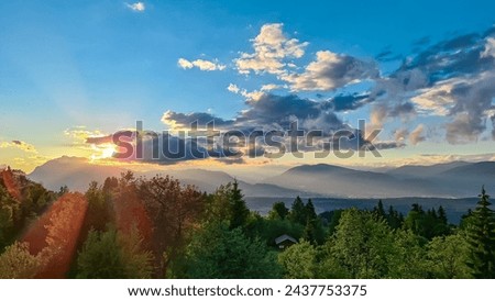 Scenic sunset view of mount Dobratsch and Lake Faak seen from Altfinkenstein at Baumgartnerhoehe, Carinthia, Austria. Tranquility on hiking trail. Overlooking Villach area surrounded by Austrian Alps Royalty-Free Stock Photo #2437753375