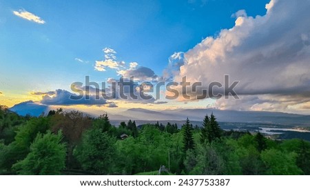 Scenic sunset view of mount Dobratsch and Lake Faak seen from Altfinkenstein at Baumgartnerhoehe, Carinthia, Austria. Tranquility on hiking trail. Overlooking Villach area surrounded by Austrian Alps Royalty-Free Stock Photo #2437753387