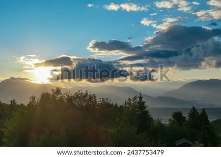 Scenic sunset view of iconic mountain peak Dobratsch seen from Altfinkenstein at Baumgartnerhoehe, Carinthia, Austria. Tranquility on hiking trail. Overlooking Villach area surrounded by Austrian Alps Royalty-Free Stock Photo #2437753479