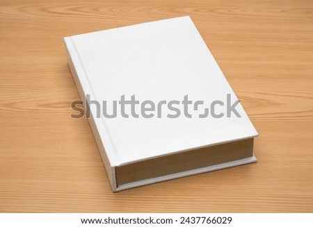 White note book on the wooden table mock up 