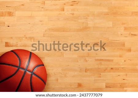 Basketball and hardwood maple basketball court floor viewed from above