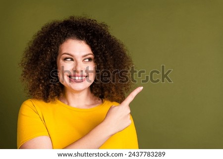 Portrait of smiling young girl chevelure hair direct finger mockup proposition market place advert isolated on khaki color background Royalty-Free Stock Photo #2437783289