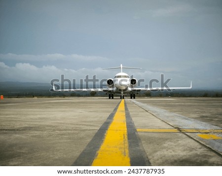 The appearance of a private airplane parked at an airport with slightly cloudy weather at the airport Royalty-Free Stock Photo #2437787935