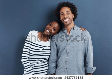 Happy, portrait and black couple hug with love on studio background together with cool fashion. African, people and smile in embrace for profile picture with casual style and clothes on mockup space