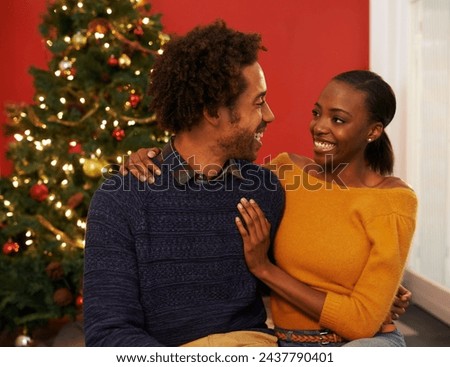 Couple, Christmas tree and festive holiday or home with happiness for vacation celebration, gifts or bonding. Man, woman and smile with lighting decoration for winter season event, together or lounge
