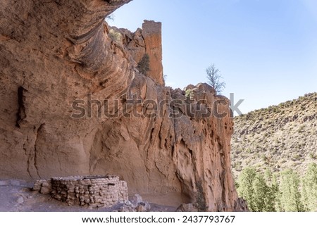 Alcove House at Bandelier National Monument preserves Ancestral Puebloan home in New Mexico. Ceremonial Cave with kiva above Frijoles Canyon. Royalty-Free Stock Photo #2437793767