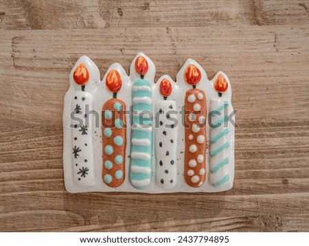 Top view of cookie with  candles for birthday in a wooden table