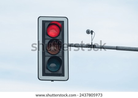 Traffic light with the color red on the pole.